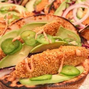 Oven baked fish taco drizzled with a chipotle sauce.