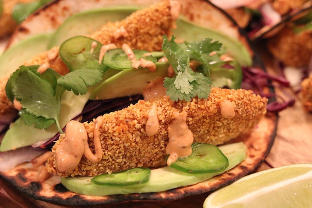 Oven-baked fish taco drizzled with chipotle sauce.