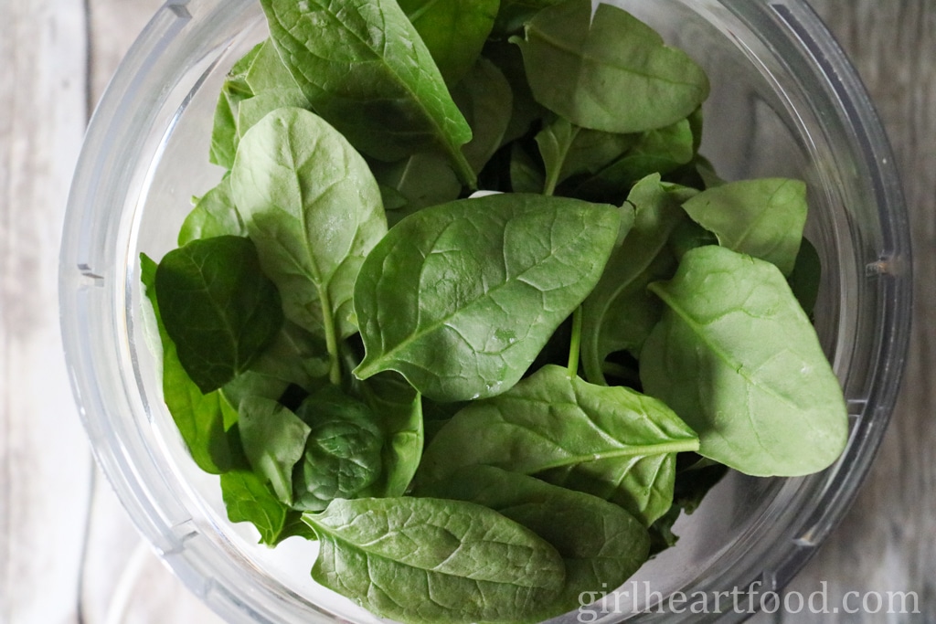 Fresh baby spinach in a food processor.