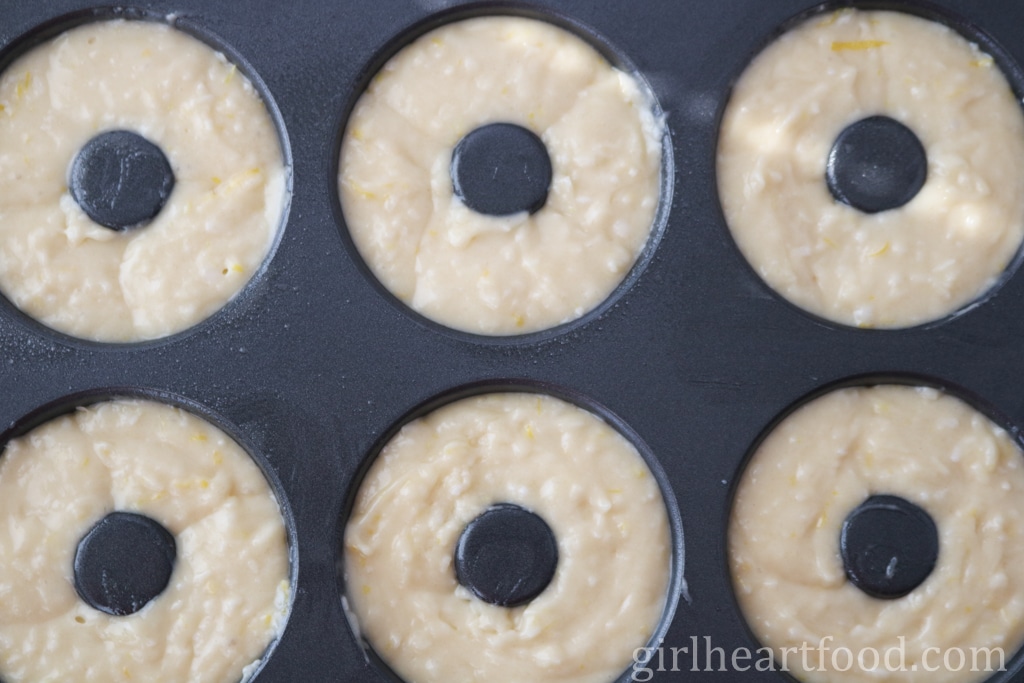 Donut batter in a pan before being baked.