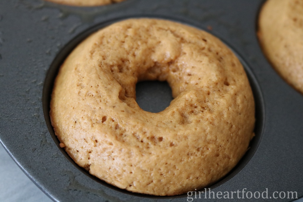 Close-up of a baked donut in a donut pan.
