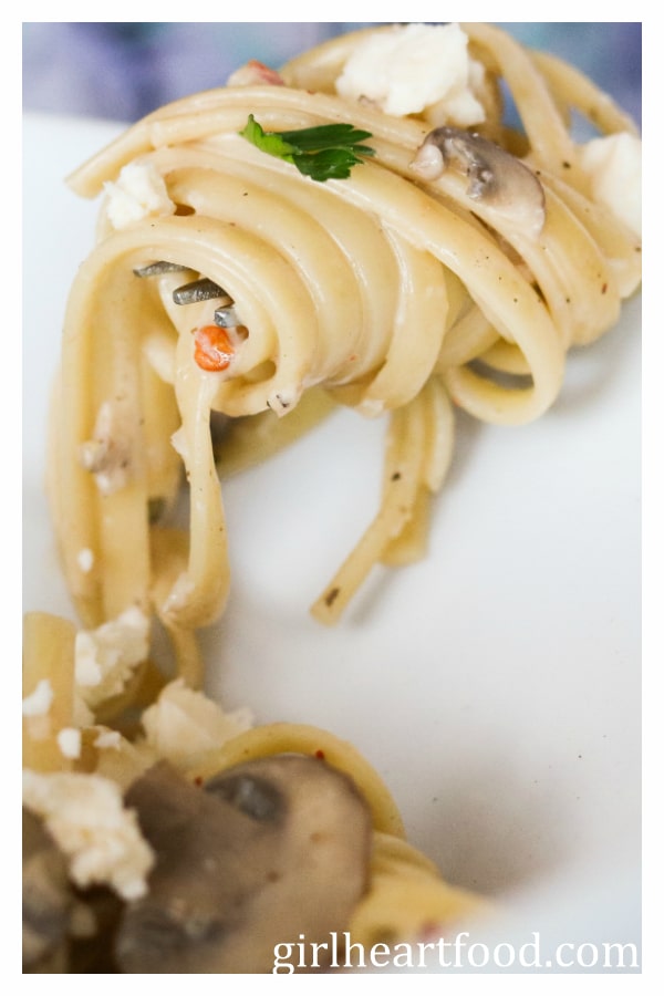 Close-up of a forkful of twirled blue cheese mushroom pasta.