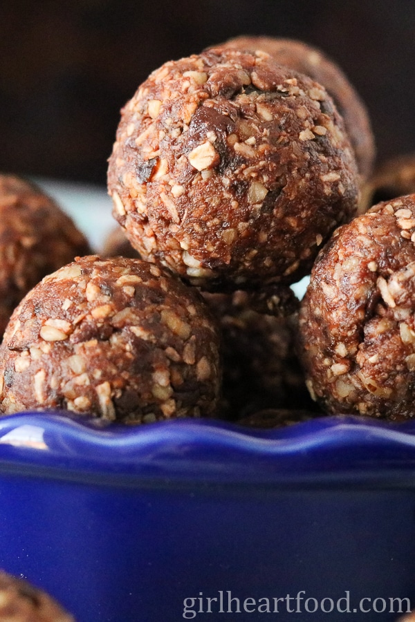 Close-up of chocolate coconut balls in a blue dish.