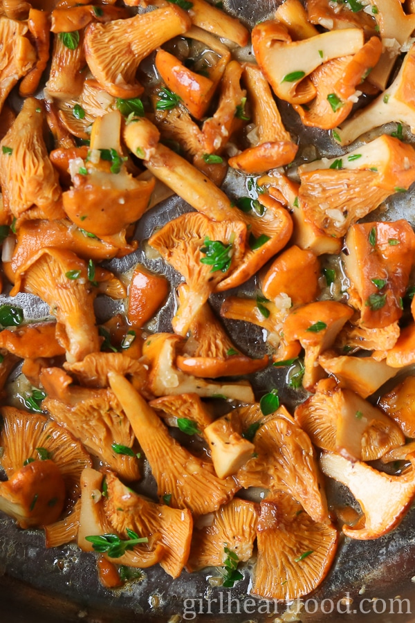 Chanterelle mushrooms cooking in a pan.