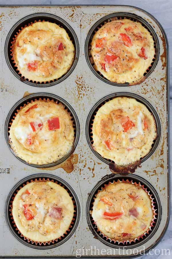 Ham and egg muffins in a muffin tin after being baked.