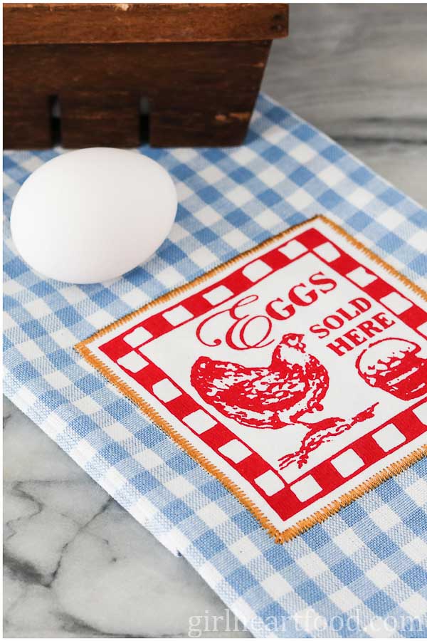 A whole egg on a tea towel.