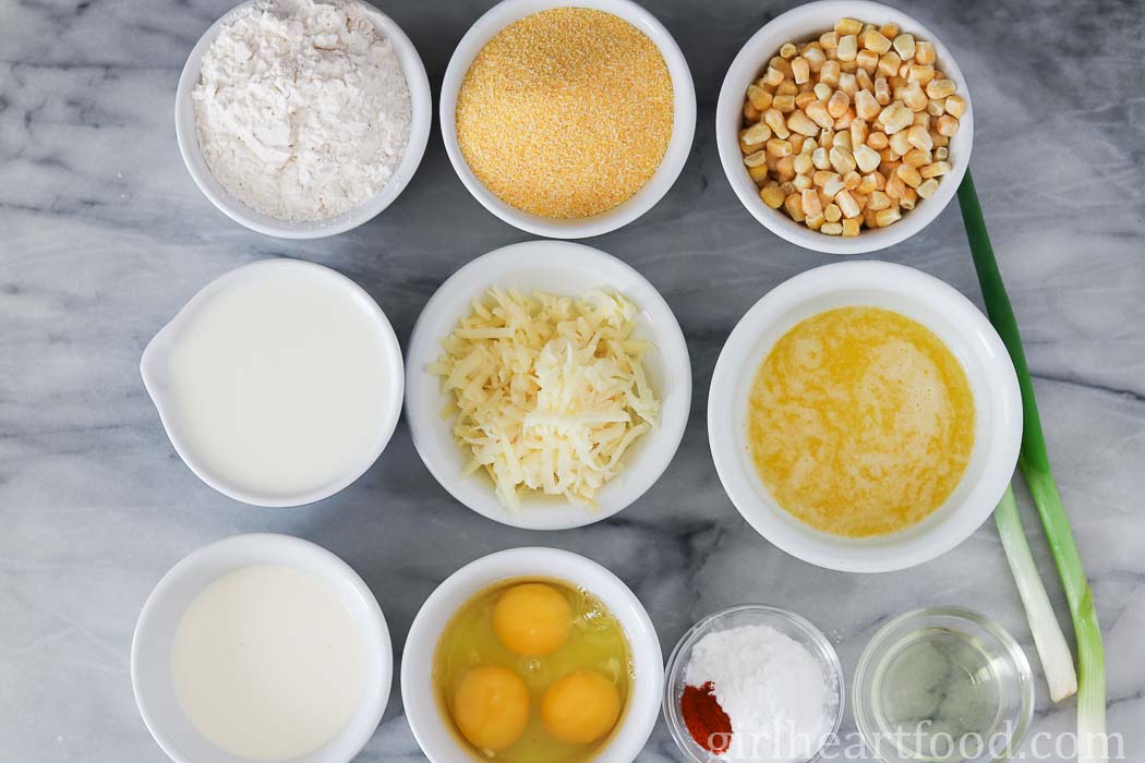 Ingredients for a skillet cornbread recipe on a marble board.