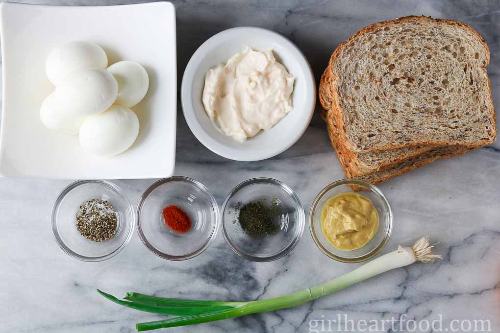 Ingredients for egg salad with dill 
on a marble board.