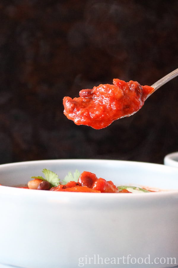 Spoonful of three bean chili from a bowl.