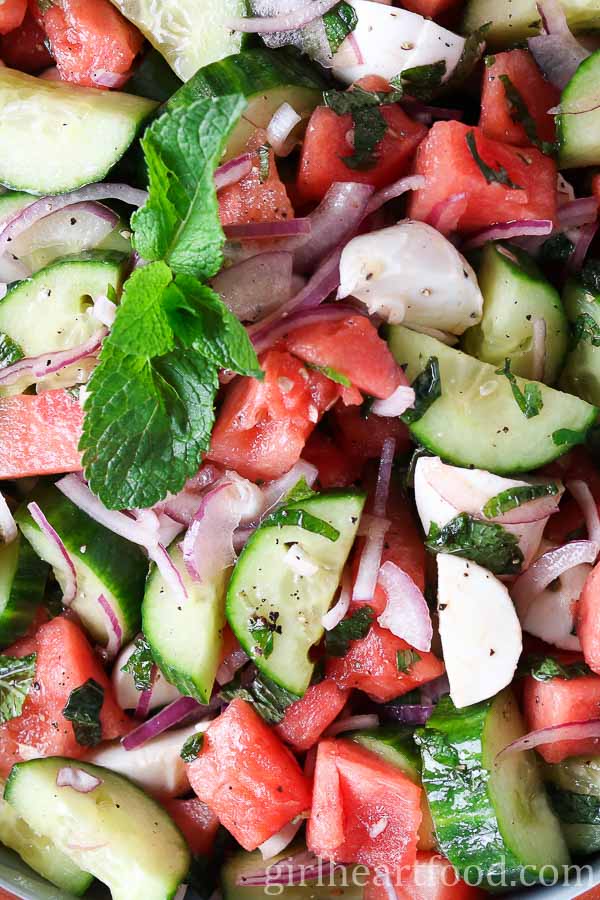 Close-up of a cucumber salad recipe with bocconcini, melon and mint.