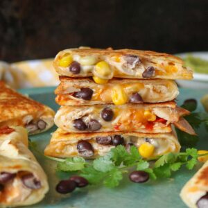 Stack of four cheesy chicken quesadillas.