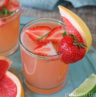 Two glasses of grapefruit rosé sangria with strawberry and grapefruit.