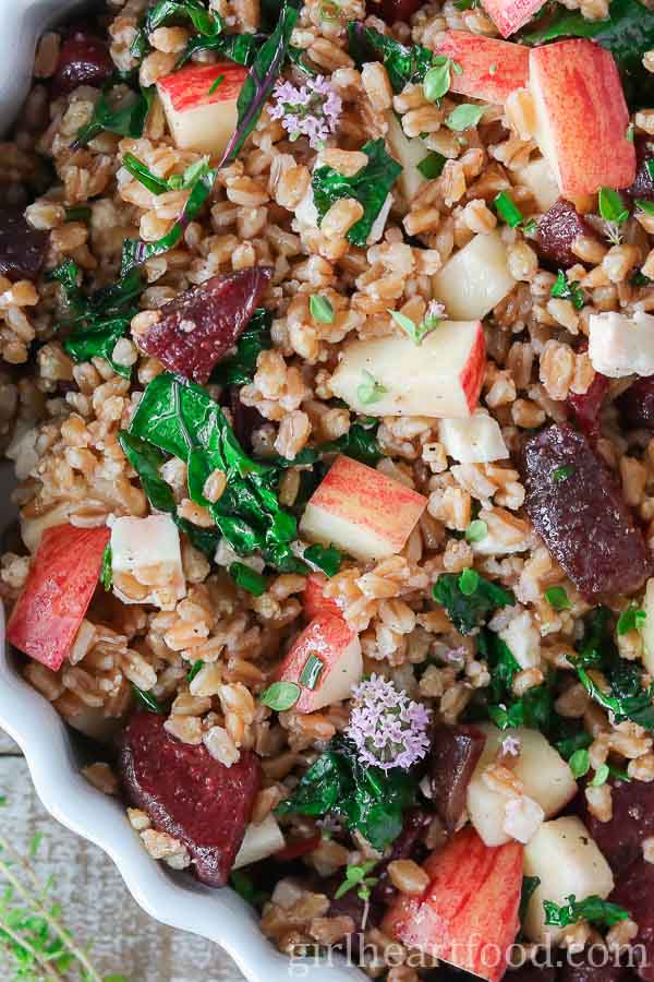 Farro salad in a dish garnished with thyme flowers.