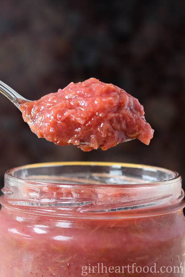 Spoonful of rhubarb jam from a jar.