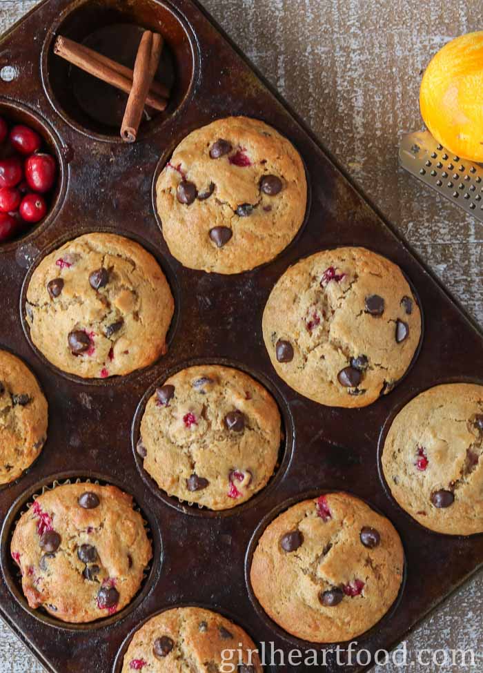 Cranberry orange chocolate chip muffins in a muffin pan.