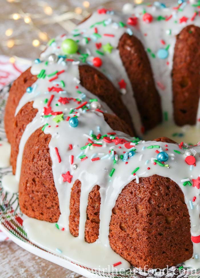 A gingerbread bundt cake with an icing sugar glaze and sprinkles.