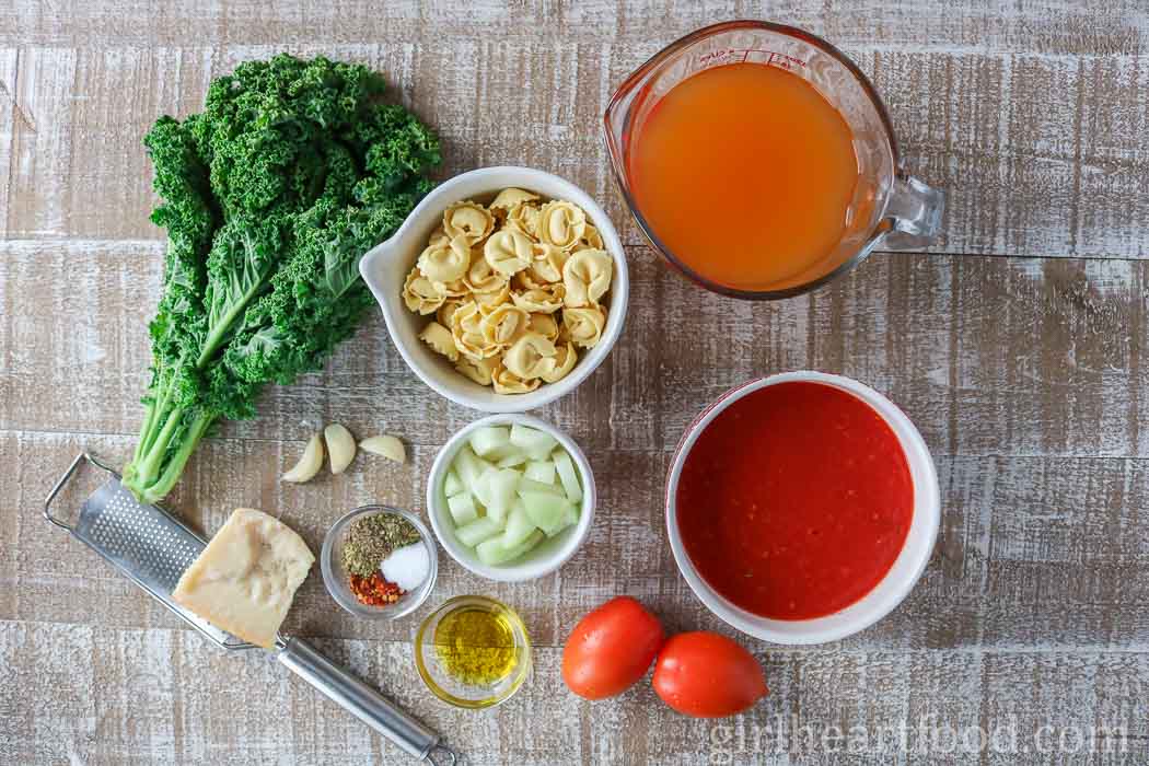 Ingredients for a tomato tortellini soup recipe.