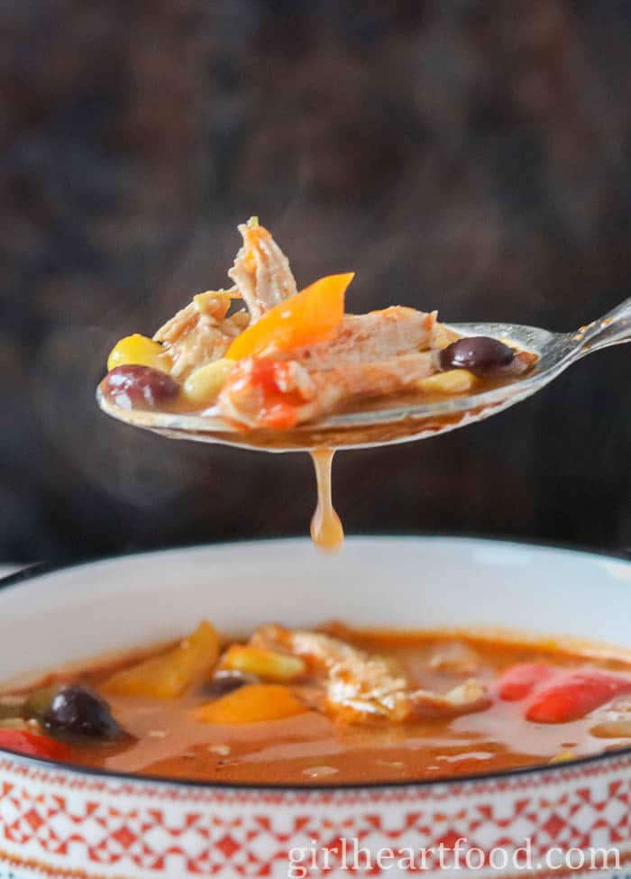 Spoonful of chicken taco soup from a bowl.