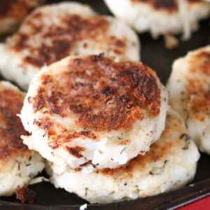 Close-up of cooked traditional Newfoundland salt cod fish cakes on a sheet pan.
