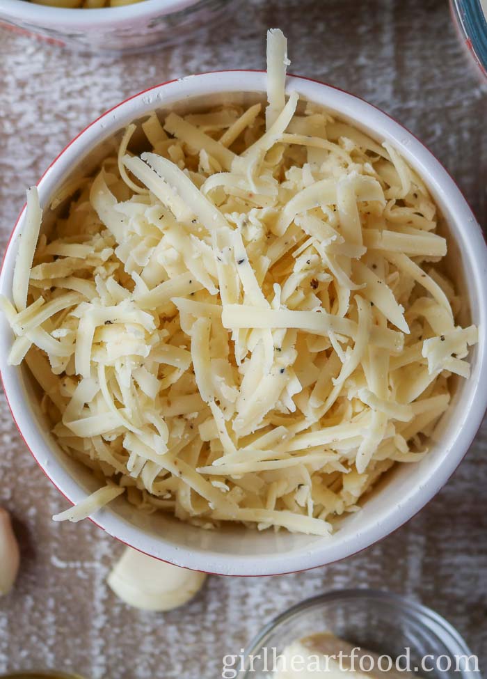 Bowl of shredded truffle cheddar cheese.