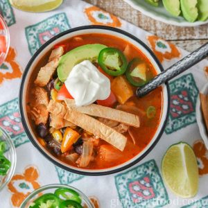 Bowl of chicken taco soup garnished with toppings and dollop of yogurt.