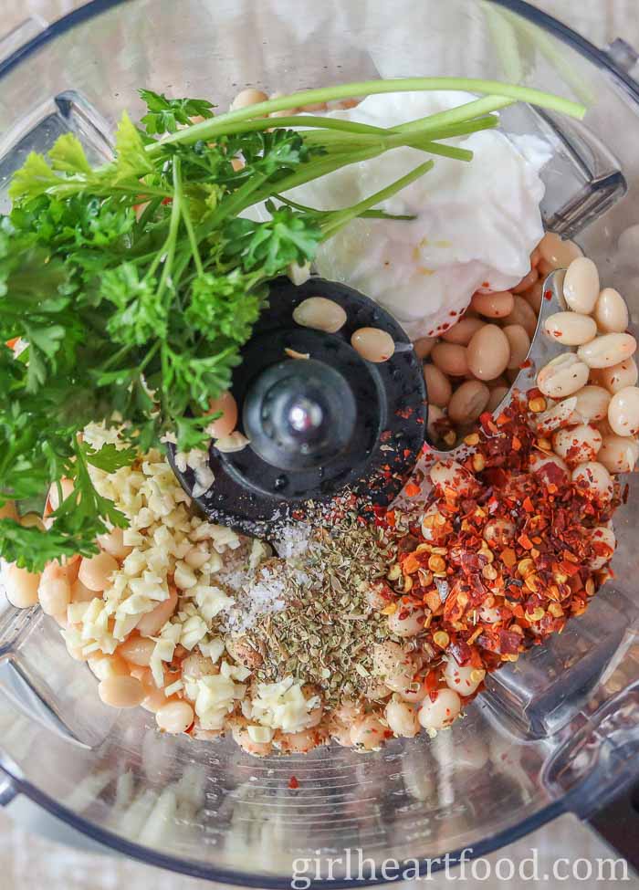 Ingredients for bean dip in a food processor before being processed.