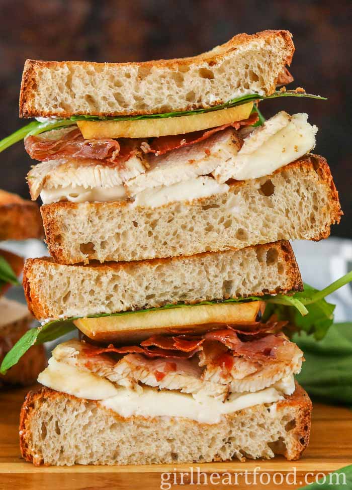 Stack of two halves of a chicken and prosciutto sandwich.