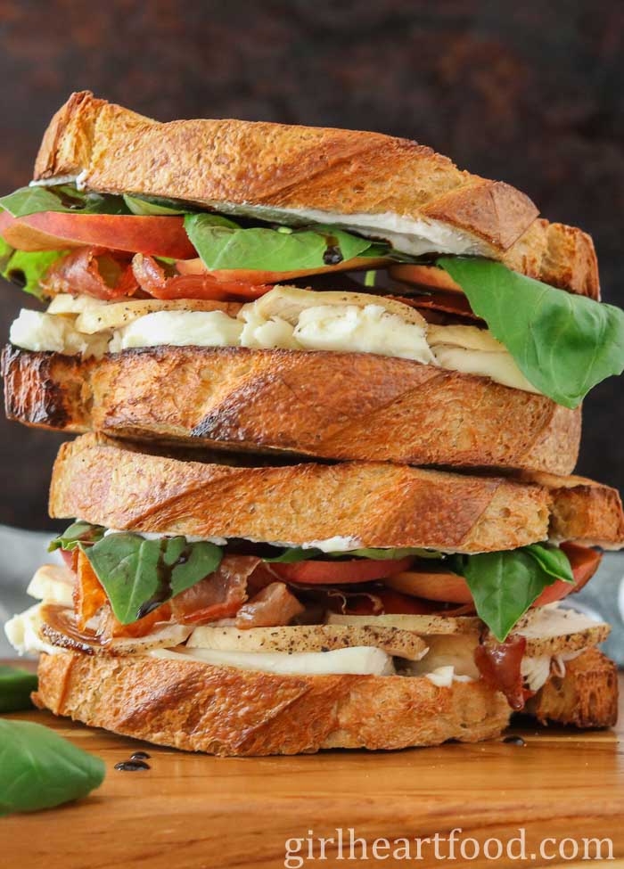 Stack of two chicken and prosciutto sandwiches.