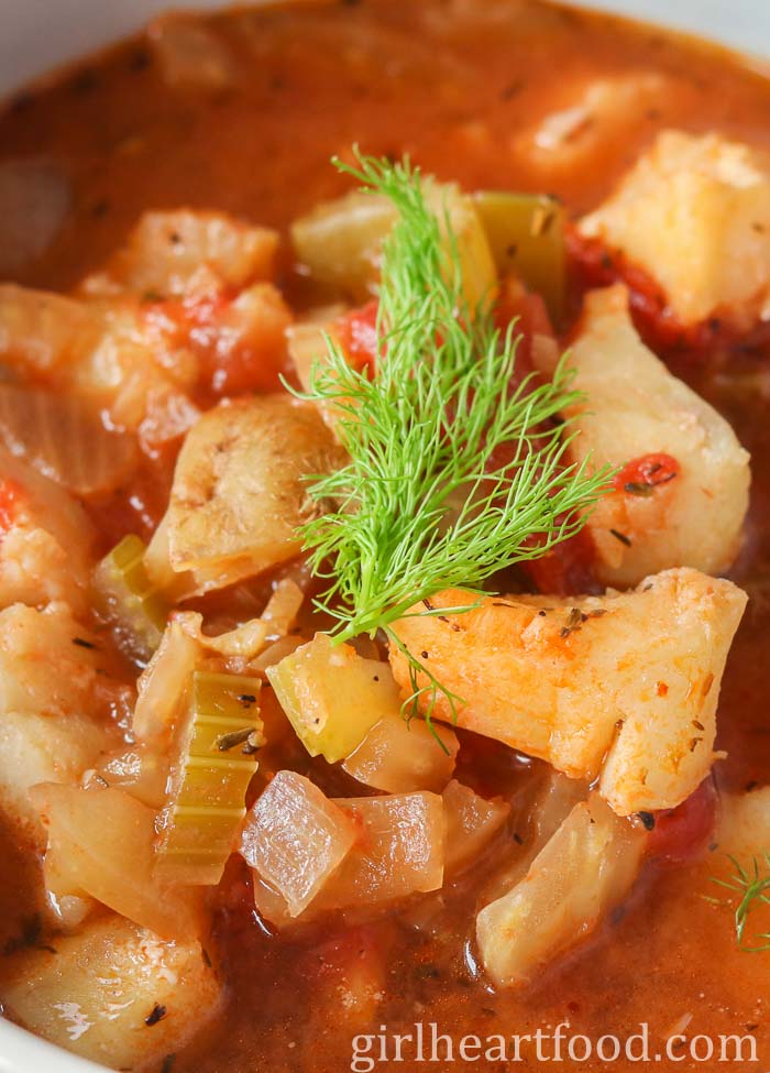 Tight close-up of fish stew with fennel.
