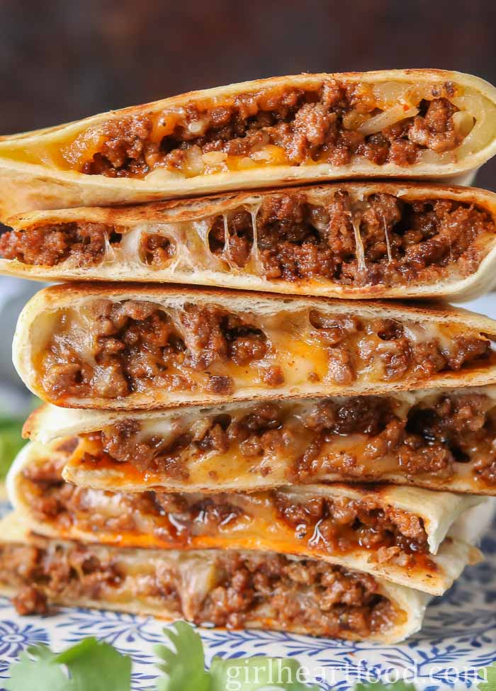 Close-up of a stack of six beef and cheese quesadillas.