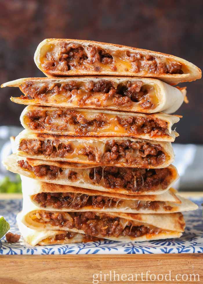 Stack of eight cheesy ground beef quesadillas.