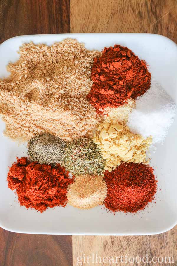 Dry rub spices for oven-baked ribs on a white plate.