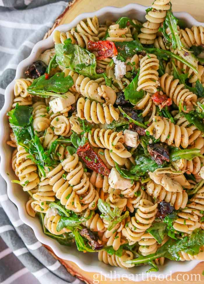 Close-up of a bowl of Mediterranean pesto pasta salad.