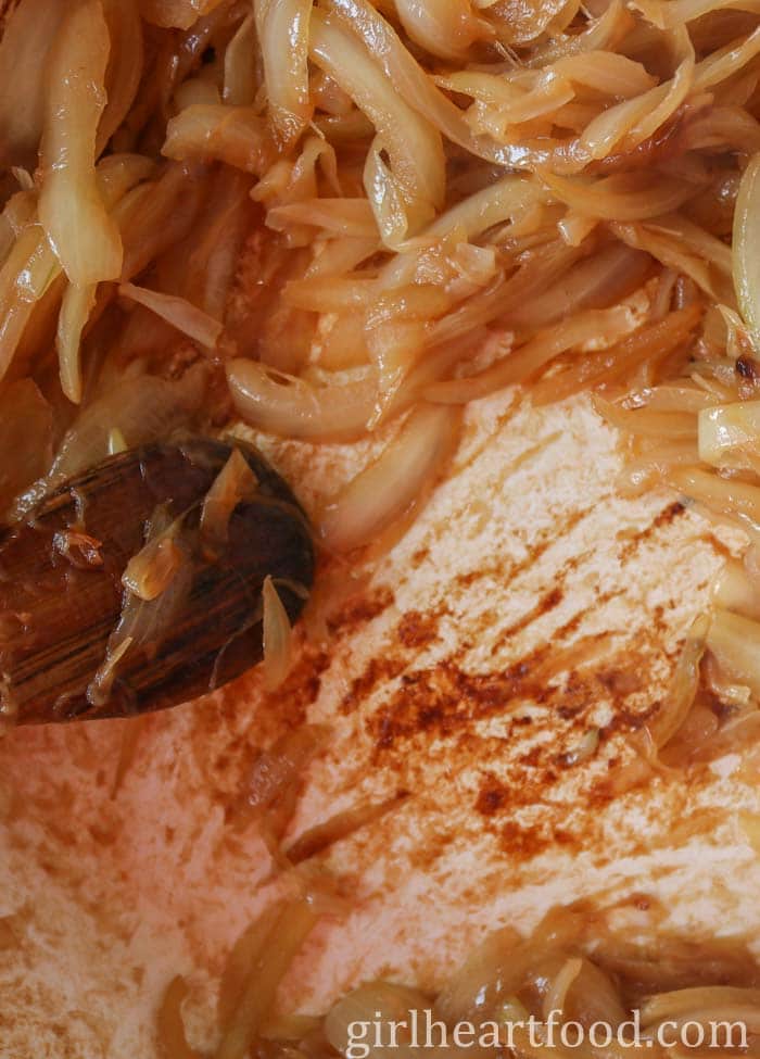 Using a wooden spoon to scrape the brown bits off the bottom of the pan while cooking onions.