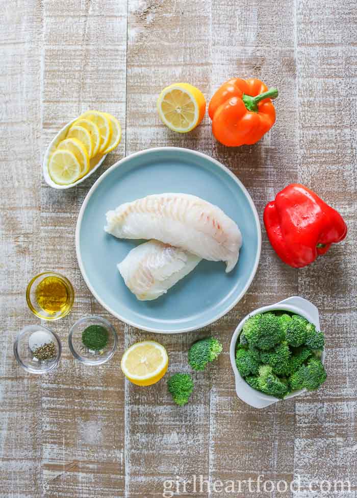 Ingredients for a baked cod and vegetable recipe.