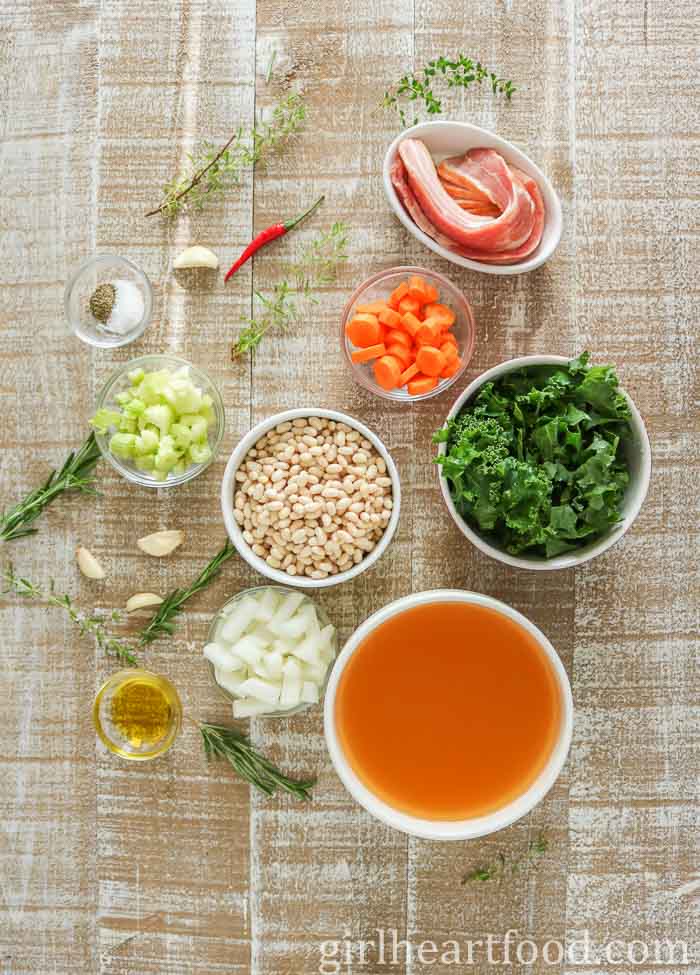 Ingredients for a navy bean, vegetable and bacon soup recipe.