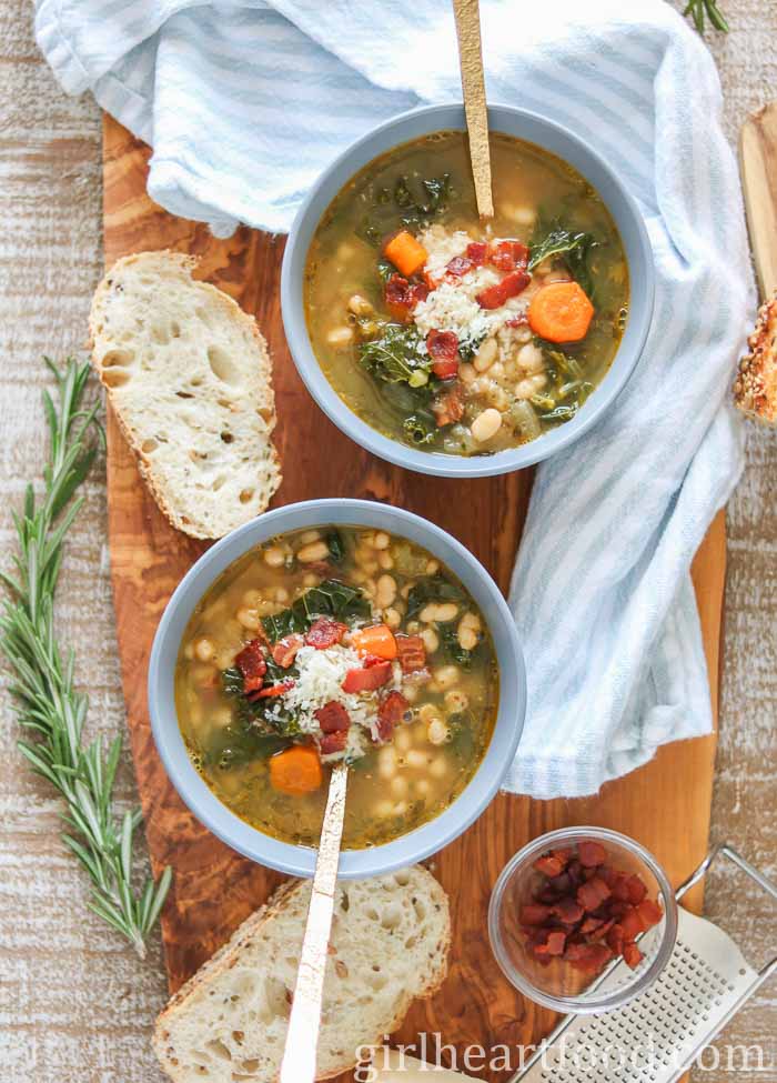 Two bowls of veggie, bean and bacon soup.