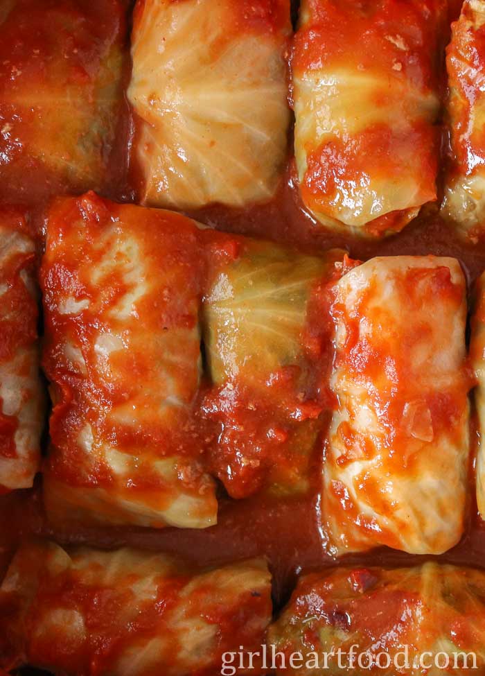 Stuffed cabbage rolls with tomato sauce on top.