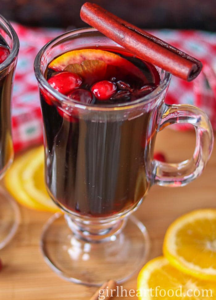 Mug of mulled wine with a cinnamon stick resting on top.