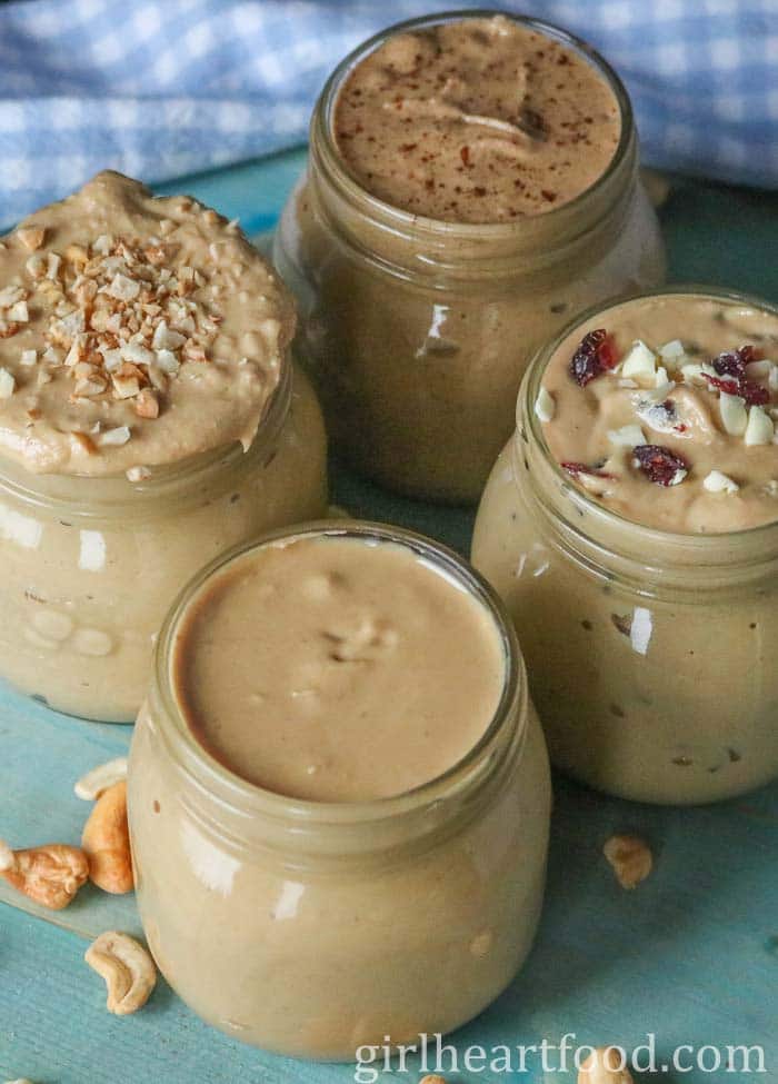 Four jars of homemade cashew butter, each a different flavour.