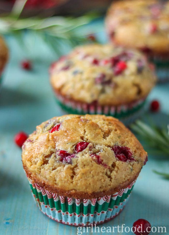 Partridgeberry muffins on a blue board.