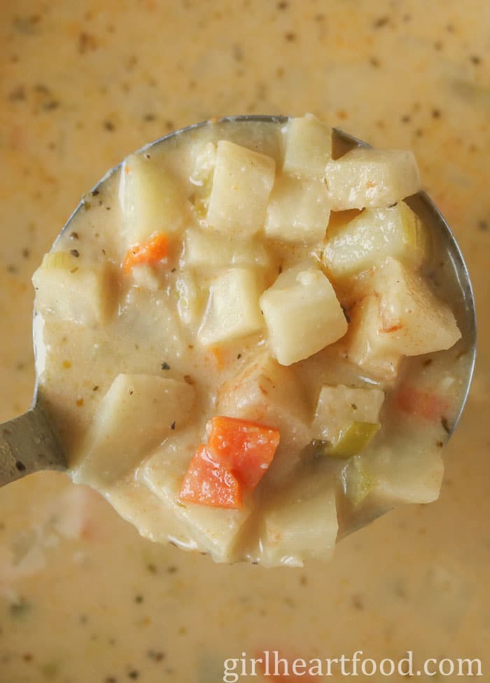 Close-up of a ladle of celery root soup.