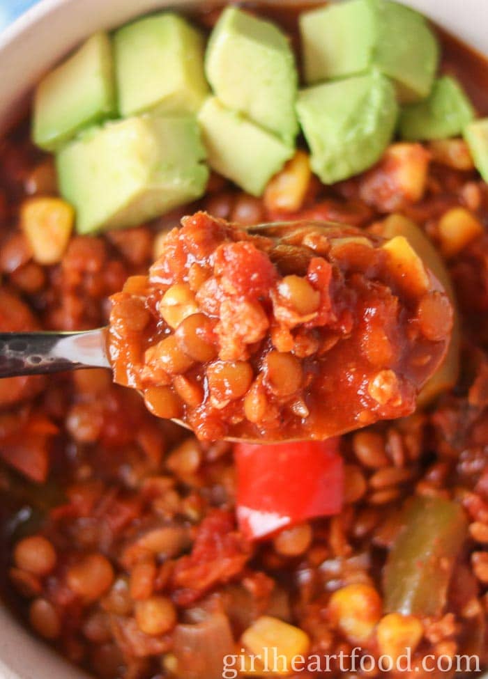 Spoonful of lentil chili from a bowl.