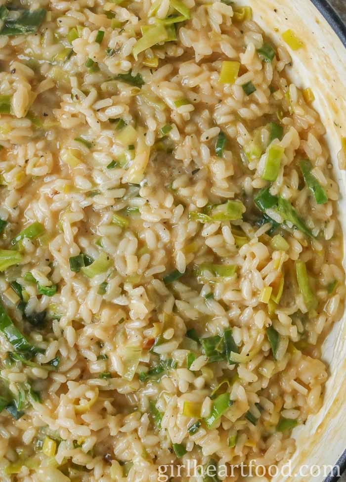 Close-up of creamy leek risotto in a pan.