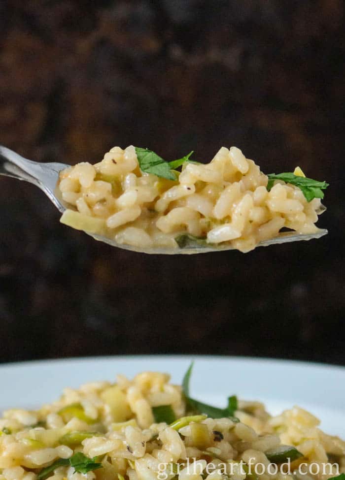 Forkful of risotto from a bowl.