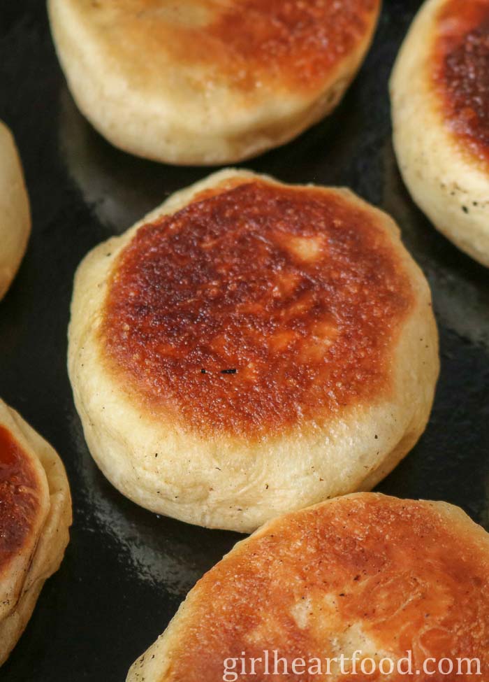 Pan-fried toutons in a cast-iron skillet.