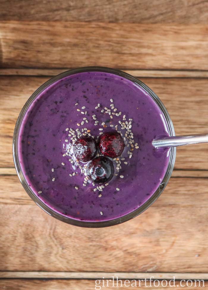 Blueberry mango smoothie topped with chia seeds and blueberries.