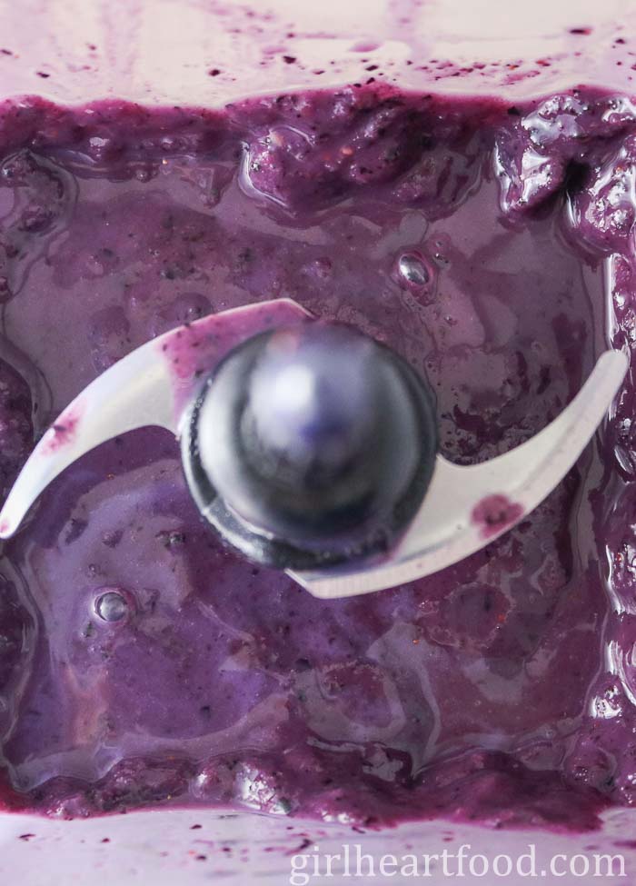 A purple fruit smoothie in a blender.