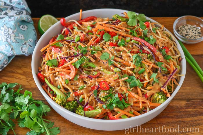 Noodles with peanut sauce and vegetables in a dish.