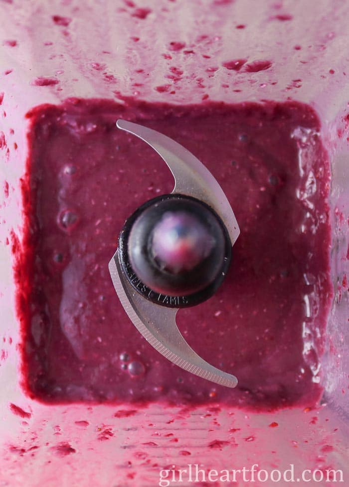 Purple-coloured fruit smoothie in a blender.